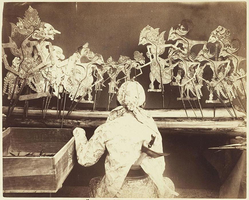 A dalang performing wayang kulit in Java, circa 1890.