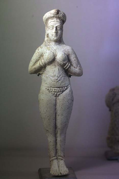 Molded naked figure holding breasts. Between 1300 and 1100 BC.