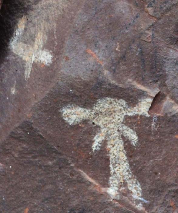Petroglyphs at Palatki, near Sedona.  A humanoid figure seems to be wearing some type of helmet, while a craft flies through the sky above. 
