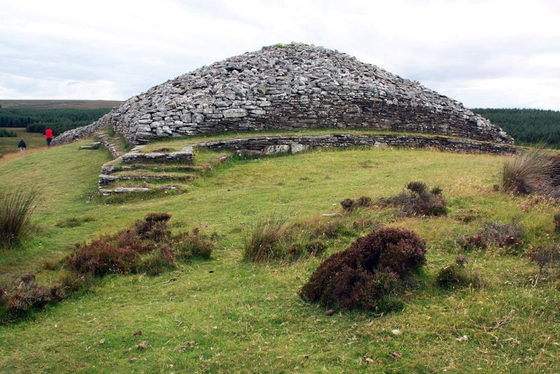 The Grey Cairns of Camster, two ancient Neolithic chambered cairns in Caithness, Scotland, feature complex architecture with central burial chambers accessed via narrow passages.