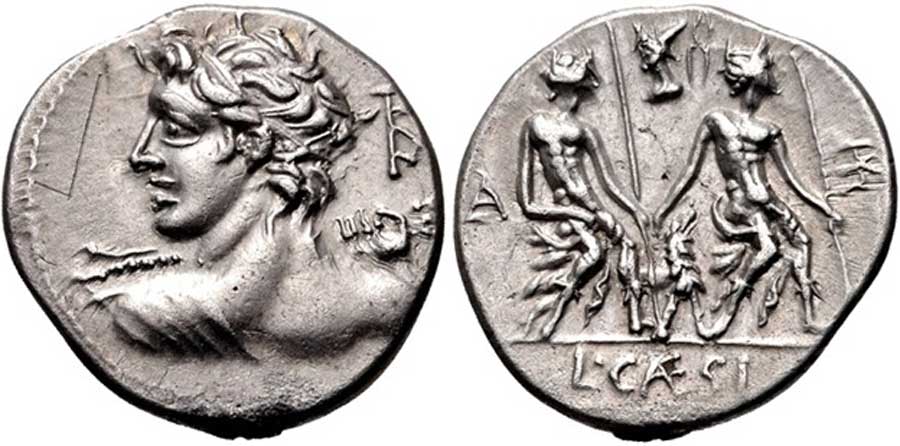 112-111 BC. AR Denarius Rome mint. Heroic bust of Apollo-Vejovis left, preparing to hurl thunderbolt; ROMA monogram behind / Two Lares seated right, each holding a staff; dog between them, head of Vulcan and tongs above. (CC BY-SA 2.5)