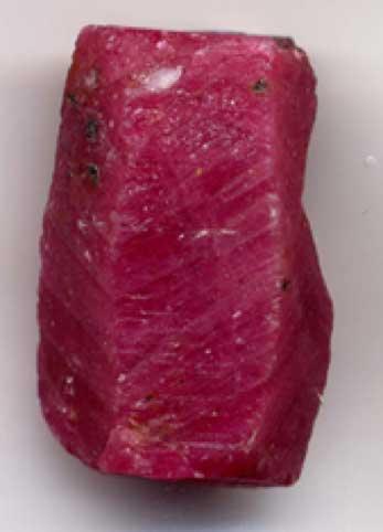 A naturally occurring ruby (corundum) crystal before faceting. Length 0.8 inches (2 cm). (Public License).