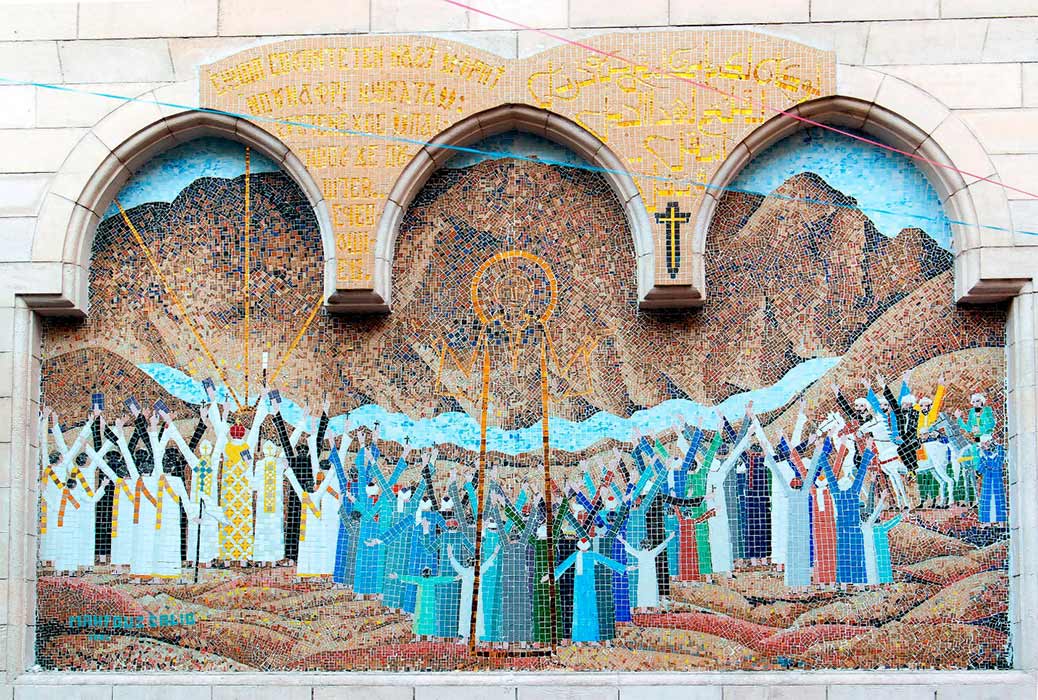 Mosaic representing Jesus Christ at the entrance of a small Coptic church with a wooden column porch in the Christian quarter of Cairo ( peizais/ Adobe Stock)