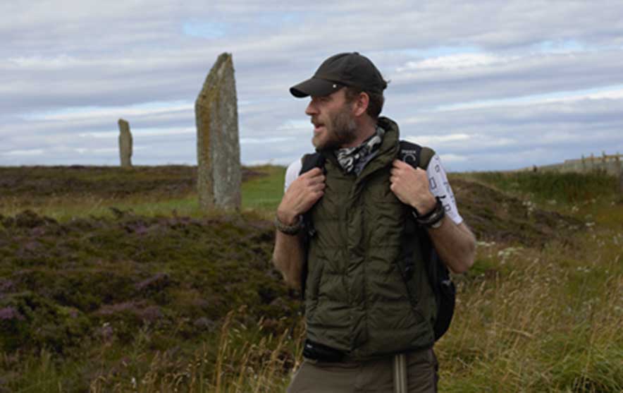 Ashley Cowie at The Ring of Brodgar Neolithic henge and stone circle located about 6 miles (9.6 kilometers) north-east of Stromness on the Mainland, the largest island in Orkney, Scotland. This stone temple is part of the UNESCO World Heritage Site known as the Heart of Neolithic Orkney. (Image: Ashley Cowie)