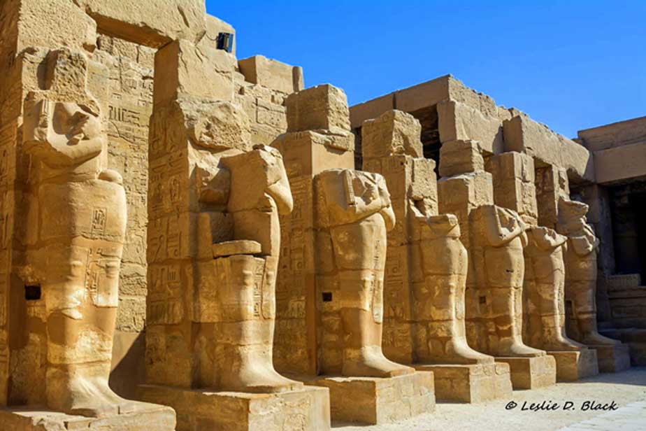 Colonnaded forecourt of the barque-shrine temple of Ramesses III, Heka-iunu, with Osiride statues of the king. The temple is remarkable for this period at Karnak, in that, it was built entirely of new material (predominantly sandstone).