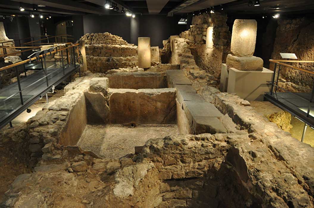 Remains of an ancient Roman salt fish factory and garum factory in the archaeological underground ruins at Plaça del Rei. 
