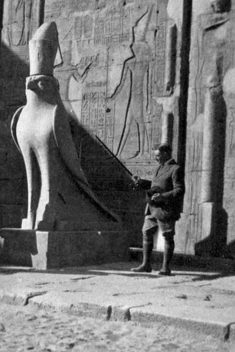 English Egyptologist and journalist, Arthur Weigall, beside a statue of Horus at the temple of Edfu in 1913 or shortly before. 