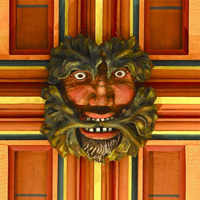 Green Man painted on a wooden roof boss in Rochester Cathedral, Kent (medieval). (Public Domain).