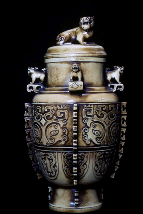 Ivory vase with cover, after the ancient bronze Hu.  Displaying the taotie (t’ao-t’ieh) and lions in its design.  Chinese, contemporary.  (Image: © Walther G. von Krenner)