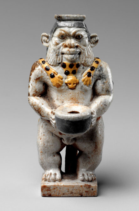 Made of faience, this squat human form with leonine features is commonly identified as the god Bes, but several other minor Egyptian gods were also represented by this image. These were protective deities, so they appear frequently as apotropaic figures in the decoration of furniture and personal belongings. Here, the god stands holding the cap of a kohl container. 27th Dynasty, Late Period. Metropolitan Museum of Art, New York.