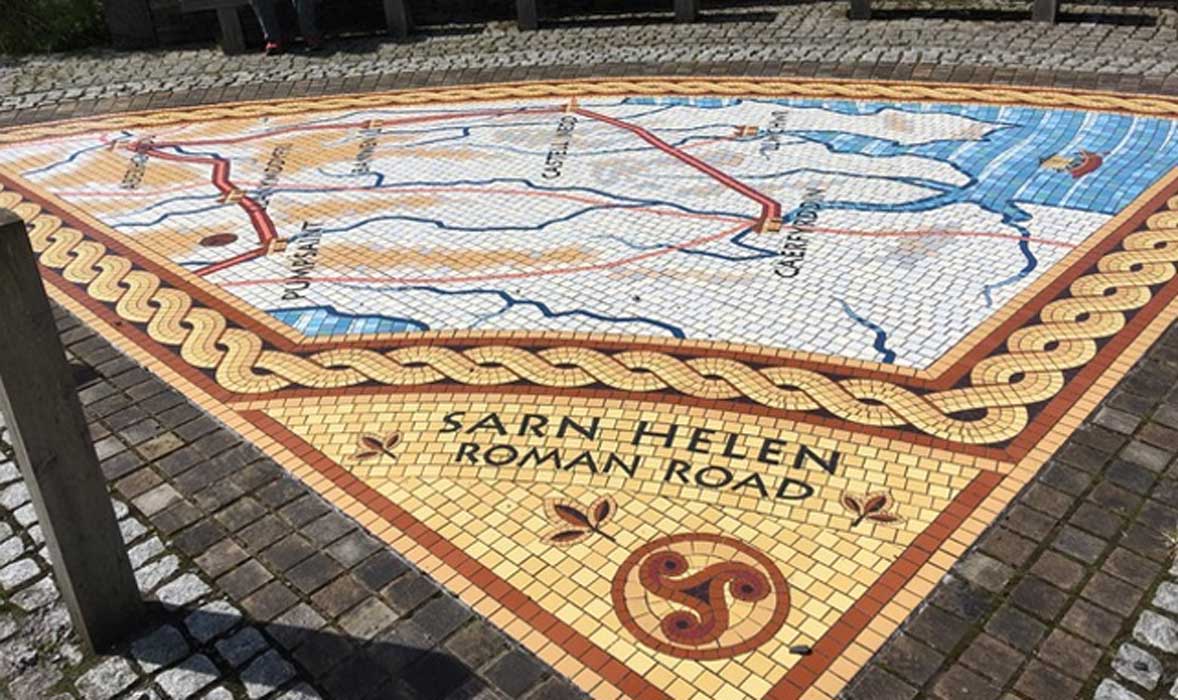 Pavement mosaics showing ‘Sarn Helen’ routes in Wales, one of which lies between the two mosaics. 
