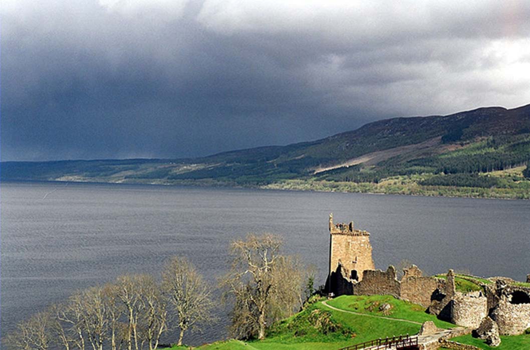 Looking south across Loch Ness from Urquhart Castle, Boleskine House is the white cottage on the hillside. Many locals claim sightings of the Loch Ness Monster increased after Crowley resided here. 