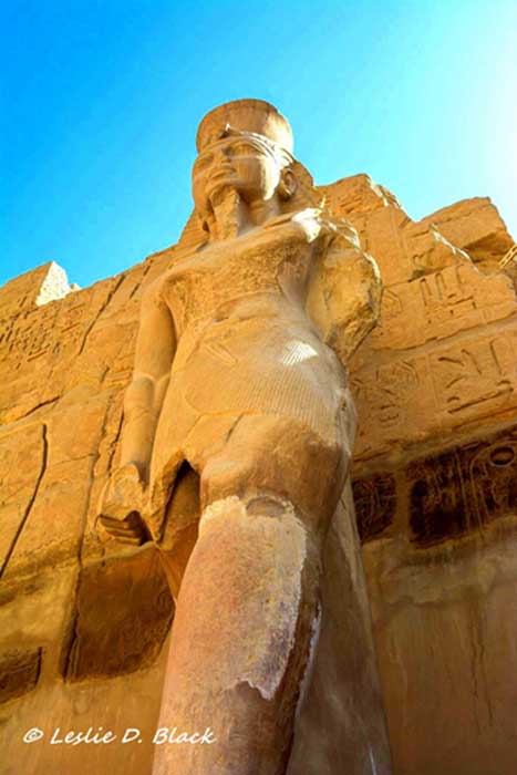 The eastern colossus of Ramesses III, standing at around 6 meters against the pylon entrance to the barque-shrine temple at Karnak; erected by the king to receive the barques of the Theban triad. The Pylon that featured traditional scenes of the king smiting his enemies only differed from Karnak’s other similar entrances in its lack of flagstaffs.