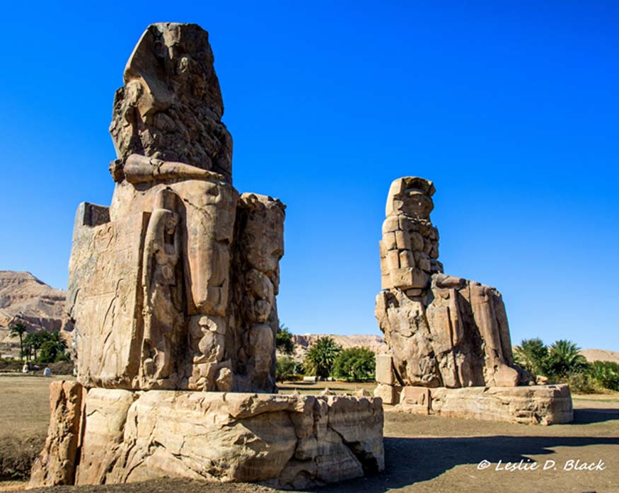 The gigantic Colossi of Memnon, made of quartzite sandstone, depict the enthroned Pharaoh Amenhotep III in the first pylon of the “Temple of Millions of Years” in the Theban Necropolis. Kom el-Hetan, near Luxor.