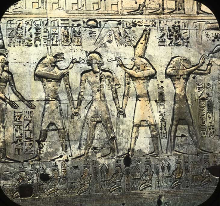 Wall reliefs from the mortuary temple of Pharaoh Seti I at Abydos show his son, Ramesses II, being given the breath of life by Wepwawet and Horus. Brooklyn Museum Lantern Slide Collection. (Photo: T. H. McAllister, New York)