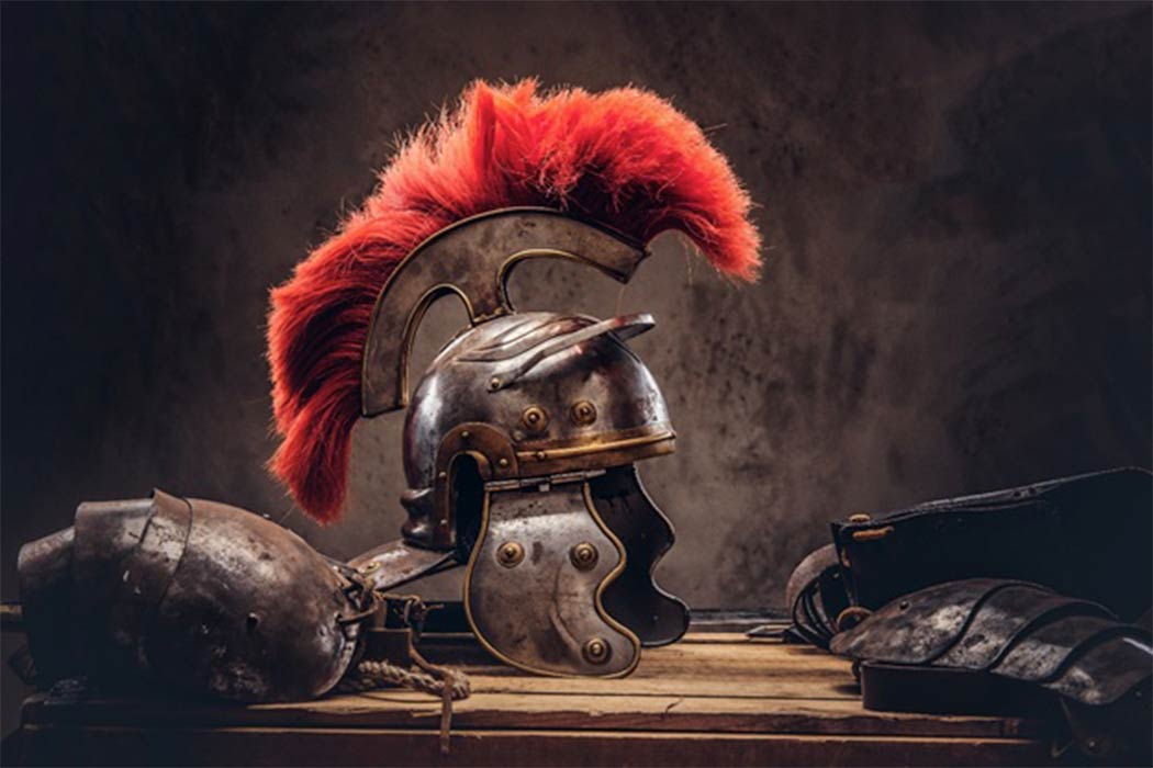Complete combat equipment of the ancient Roman warrior lie on a box of wooden boards. (Fxquadro / Adobe Stock)