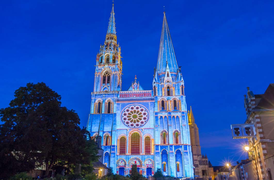 The illuminated Our Lady of Chartres cathedral, France (kovalenkovpetr / Adobe Stock)