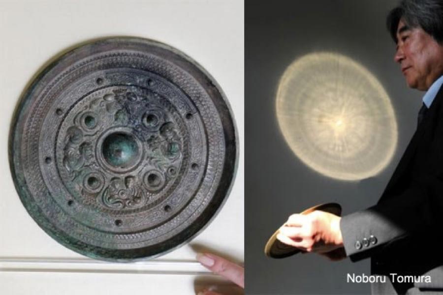An example of one of the 'miraculous' products of ancient Chinese craftsmanship. The bronze mirror is illuminated from the left. On the wall in front of it, the image that has been imprinted on the back of the mirror, appears. (You Tube)