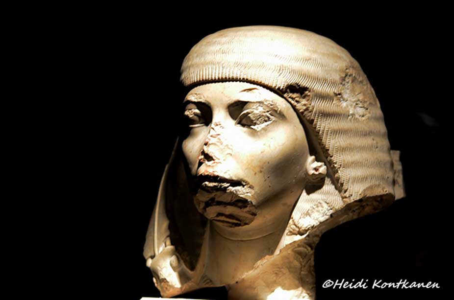 This head, part of a fragmentary monolithic pair statue of husband and wife, represents Nakhtmin, a royal scribe and general under Tutankhamun. He was designated the crown prince when King Aye came to the throne. Along the right-hand side of the wig can be seen the remains of the ostrich plume fan that served as a symbol of his rank. Luxor Museum.