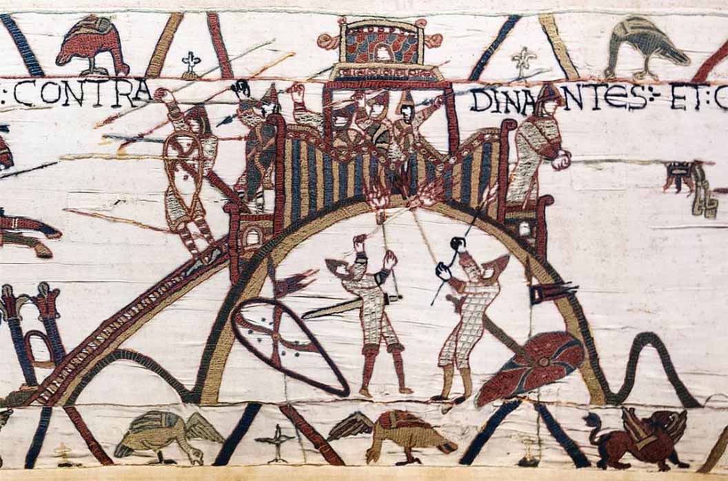 The Bayeux Tapestry contains one of the earliest representations of a castle. It depicts attackers of Château de Dinan in France using fire, one of the threats to wooden castles. (Public Domain)