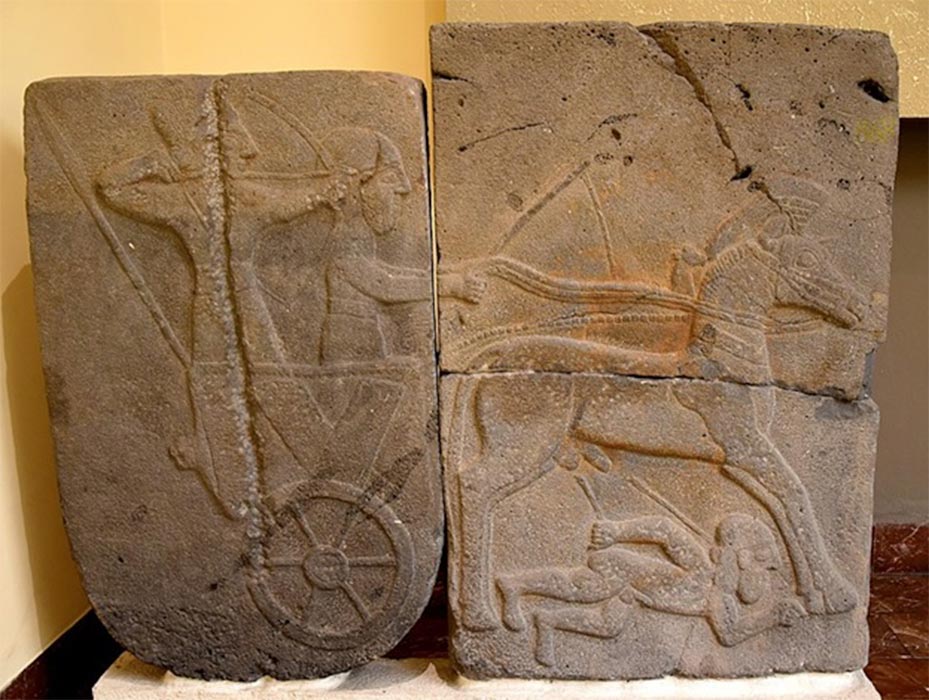 Relief orthostat showing a war chariot and a dying naked foe, from Sam'al citadel. (Ninth century BC) Museum of the Ancient Orient, Istanbul. (Public Domain)