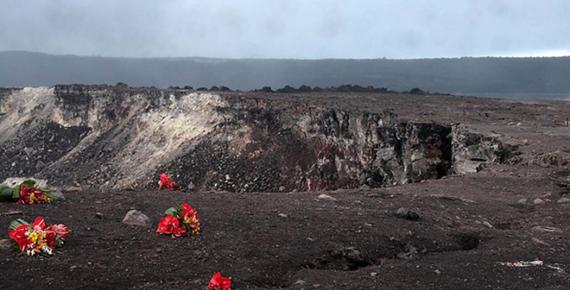 Red flowers apparently left as an offering for the volcano goddess Pele at the edge of the Halema'uma'u Crater in the Kilauea caldera at Volcanoes National Park on the Island of Hawaii.