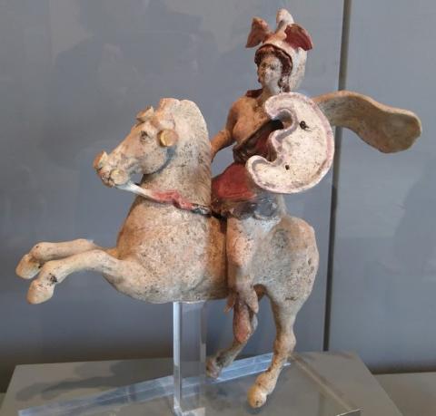 An ancient Greek figurine depicting an Amazon on horseback. 