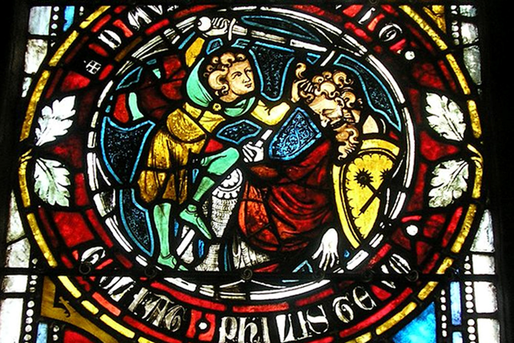 David chops off the head of the giant, Goliath. Stained glass window. 